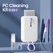11-in-1 PC cleaning kit with white brush, purple microfiber swab, spray bottle, and cleaning tools on blue background