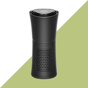 Black portable air purifier with power button on top and perforated vent design
