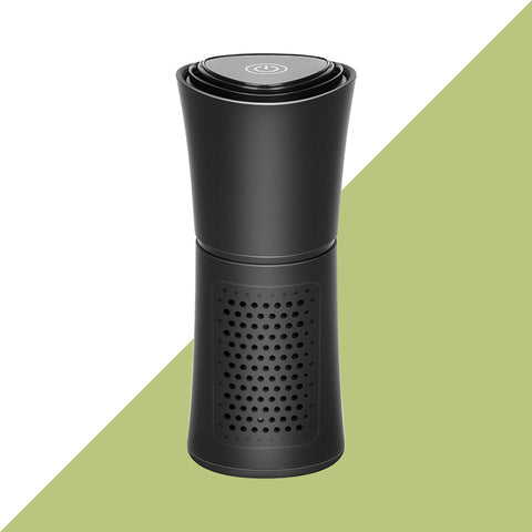 Black portable air purifier with power button on top and perforated vent design