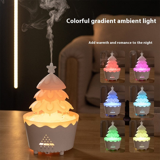Christmas tree shaped humidifier with colorful gradient ambient light emitting steam on wooden table