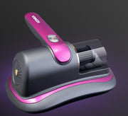 Compact gray and pink kitchen appliance with cylindrical grinder and handle on purple background