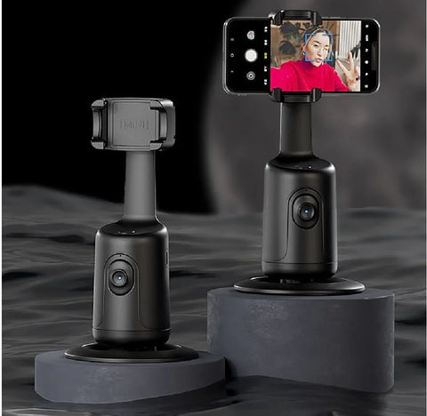 Black 360-degree AI face tracking phone holders on dark pedestals, one holding a phone with a face detected