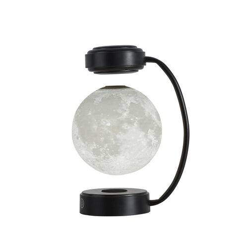 Levitating moon lamp with black curved stand and round base against white background