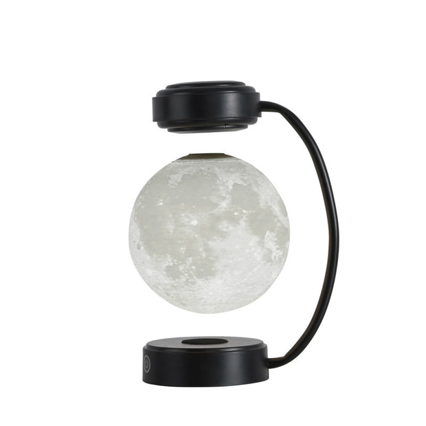 Levitating moon lamp with black curved stand and round base against white background