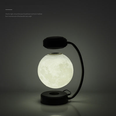 Modern levitating moon lamp with black stand glowing softly in dark room