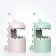 Cute dinosaur-shaped anti-mosquito lamps in pastel pink and green on white background