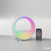 Round atmosphere lamp with colorful LED light and Bluetooth speaker, next to smartphone with app controls