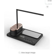 modern black desk lamp with built-in Bluetooth speaker, phone dock, and digital clock on base