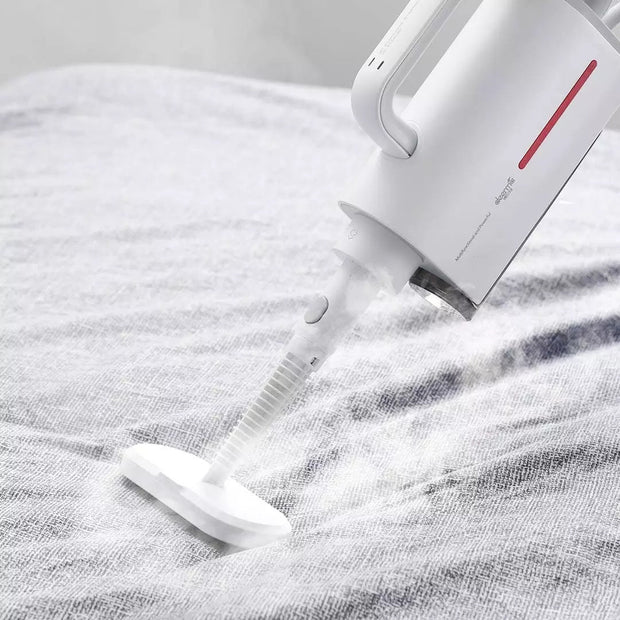 White Deerma ZQ610 steam cleaner in use, emitting steam on a fabric surface, handheld design