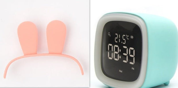 Digital desk clock in light blue with white LED display showing time 08:39 and temperature 21.5°C
