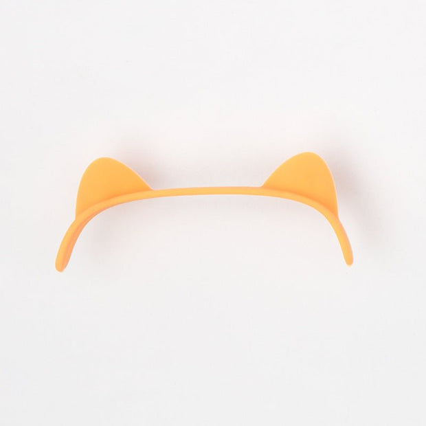 Orange cat ear-shaped plastic headband on white background