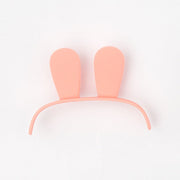 Pink plastic bunny ears headband on white background