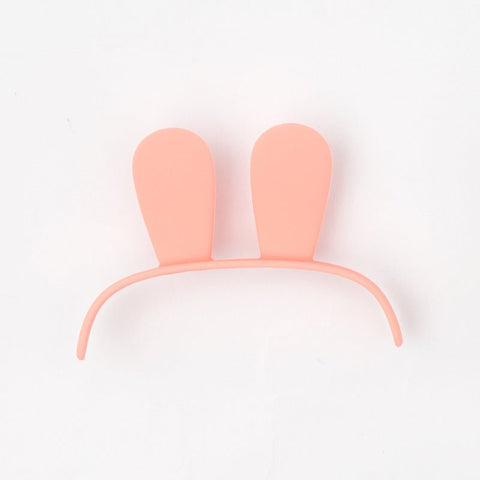 Pink plastic bunny ears headband on white background