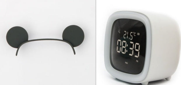 Digital desk clock with thermostat display showing 21.5°C and time 08:39 PM in white casing on white background