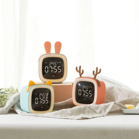 Three digital desk clocks with thermostat showing 07:55 and 24.5°C, featuring bunny, cat, and deer ear designs