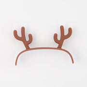 Brown reindeer antler headband on white background, festive party accessory
