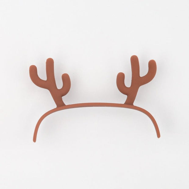 Brown reindeer antler headband on white background, festive party accessory
