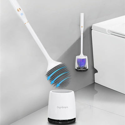 White electric toilet brush with rotating bristles and charging base beside a modern white toilet