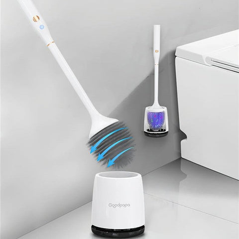 White electric toilet brush with rotating bristles and charging base beside a modern white toilet