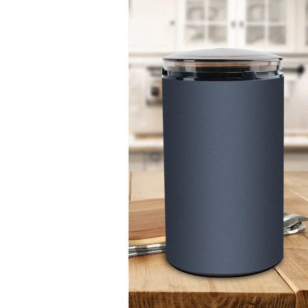 Modern electric coffee grinder with matte black finish on wooden kitchen countertop