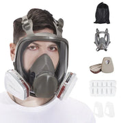 Man wearing dual filter full face gas mask with clear visor and accessories on white background