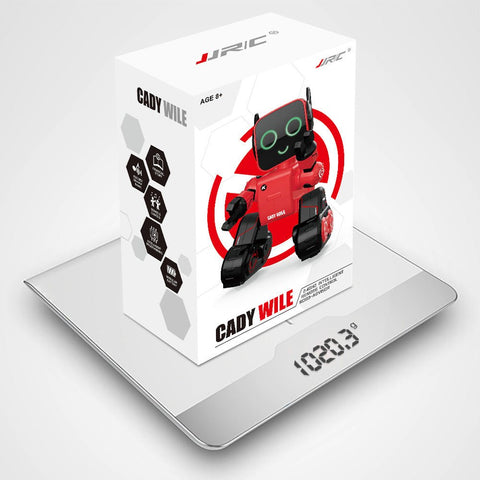 Box of Cady Wile intelligent remote control robot toy on digital kitchen scale showing weight 1020.3 grams