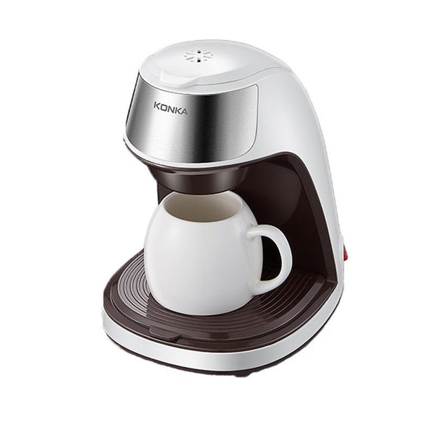 Konka compact white and silver coffee maker with a white ceramic mug on drip tray