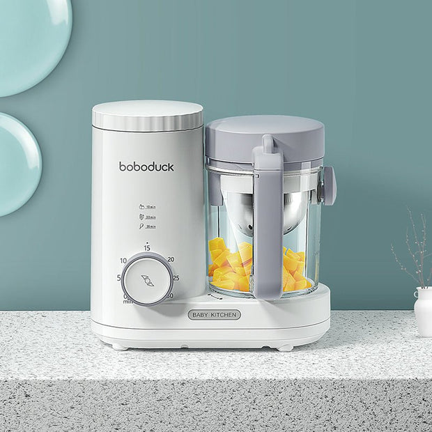 Boboduck multifunctional baby food machine with timer and chopped mango on kitchen countertop