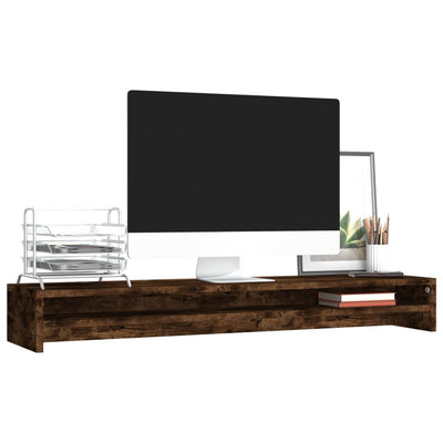 smoked oak wooden monitor stand with desktop computer, metal file organizer, framed plant art, and pencils