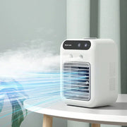 Compact white portable air conditioner on round table blowing cool air in modern room