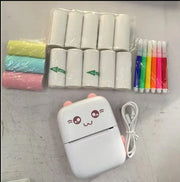 white portable Bluetooth mini printer with cute face, color markers, thermal paper rolls, and colored paper