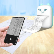 Portable Bluetooth printer with cute face printing math text from smartphone on wooden desk
