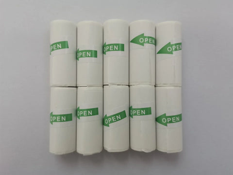 Eight rolls of white thermal paper with green 'OPEN' labels, arranged in two rows on a white surface