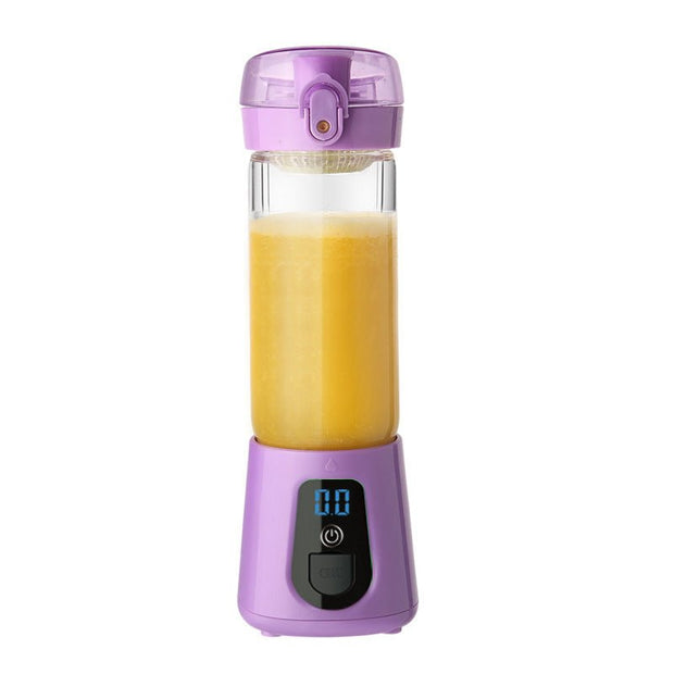Purple portable electric juicer filled with fresh orange juice on white background