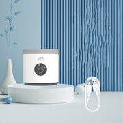 White Jiffi portable milk temperature regulator displaying 45°C with USB charging cable on blue decorative background