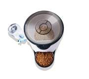 Top view of smart pet feeder with transparent lid and attached water dispenser filled with dry pet food