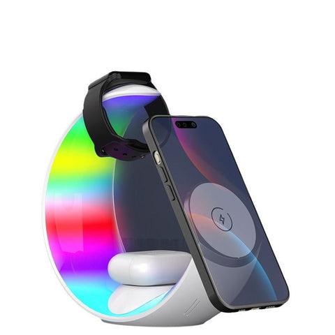 Modern wireless charging station with rainbow LED light, charging a smartphone, smartwatch, and earbuds