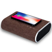 Brown wireless charger speaker with smartphone charging on top, featuring touch control buttons