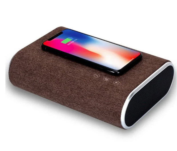 Brown fabric wireless charger speaker with smartphone charging on top, showing 79% battery