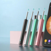 Wireless ear cleaner devices in black, silver, green, and pink next to a smartphone showing ear canal image