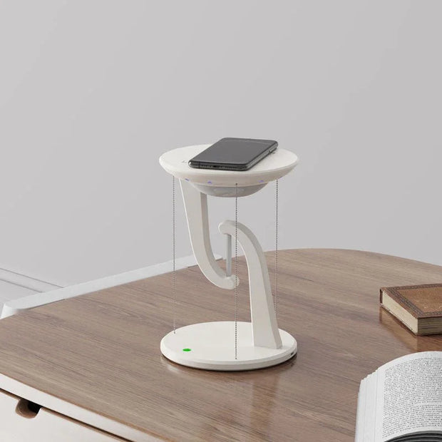 Modern white wireless floating charger with smartphone on wooden desk in minimal workspace
